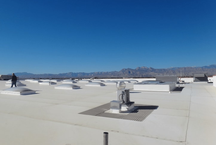 A commercial roof with mountains in the background